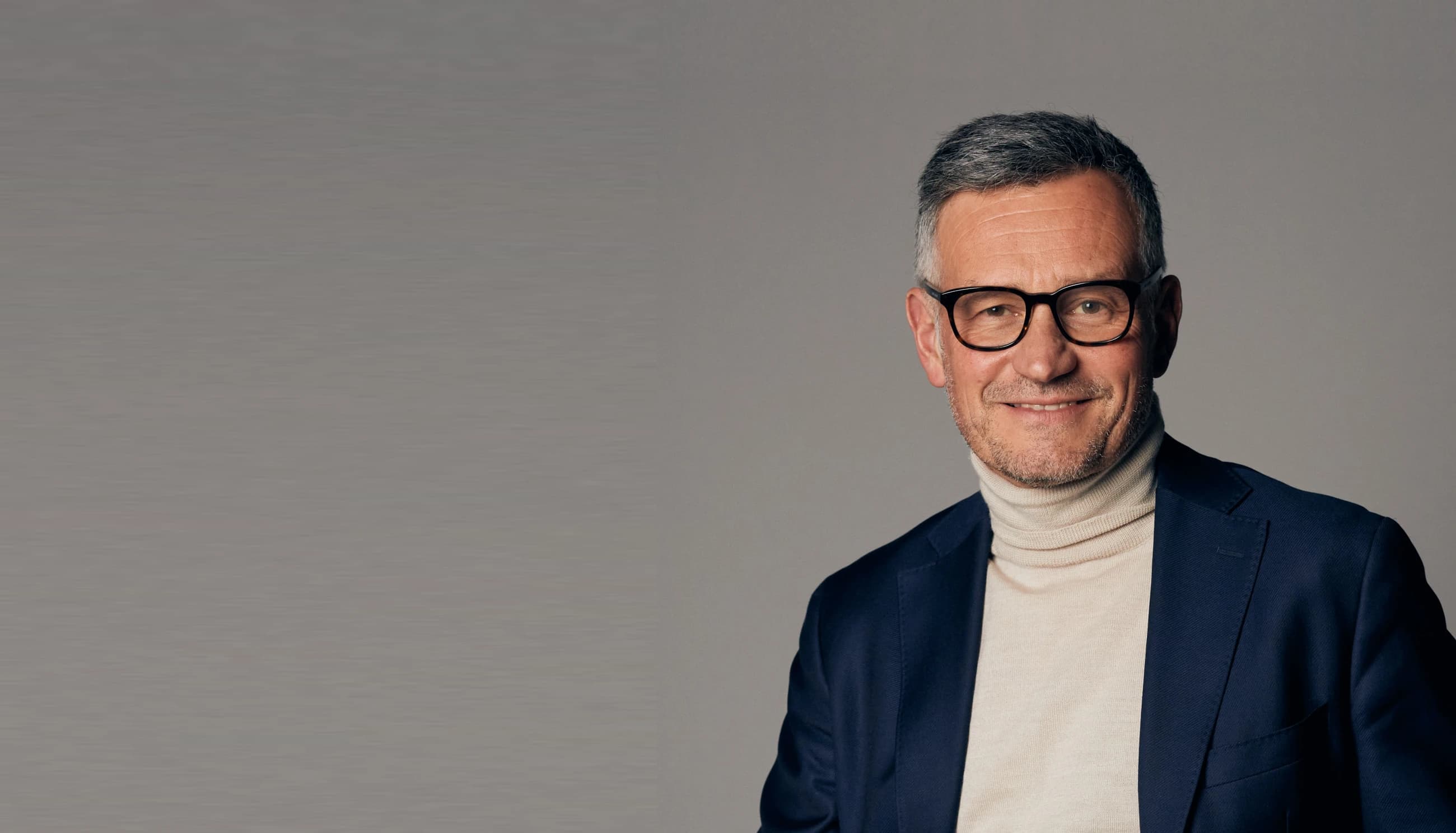 Portrait of a poised businessman in a navy suit, embodying the confidence needed to say no and set priorities.